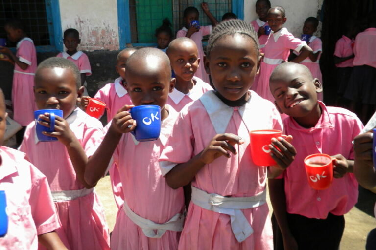 School Children with drinks in pink uniform