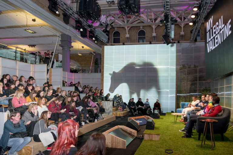 LUSH Cosmetics Old Billingsgate conference stage with audience and shadow cow image